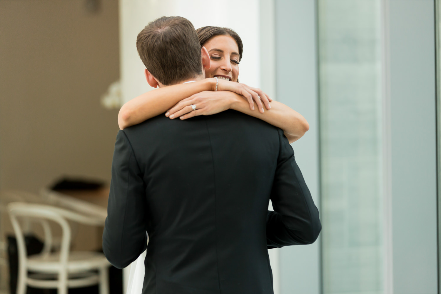 A bride hugs her fiance during their first look at the Miami Beach Edition.