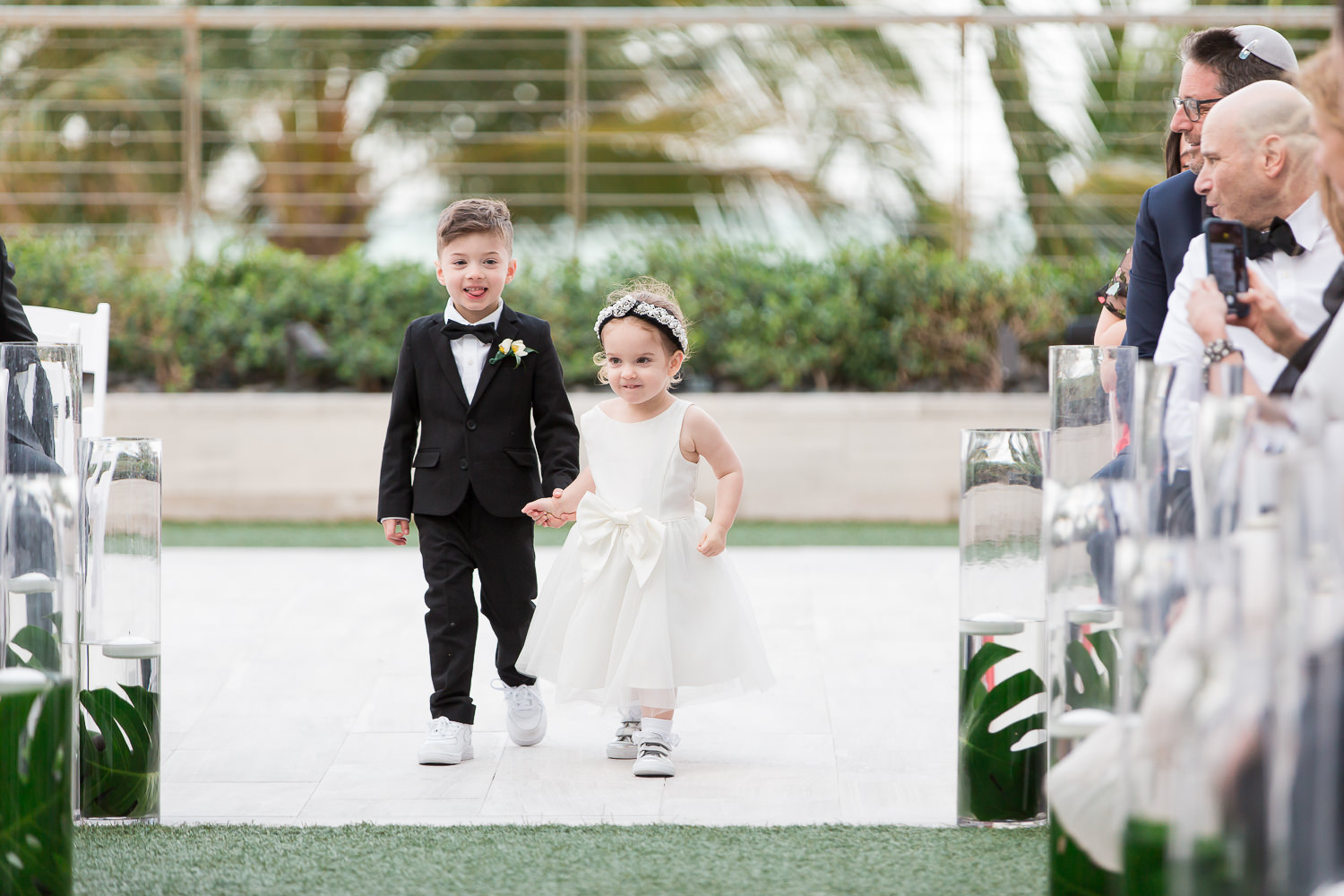 A flower girl and ring bearer walk down the aisle at the Miami Beach Edition.
