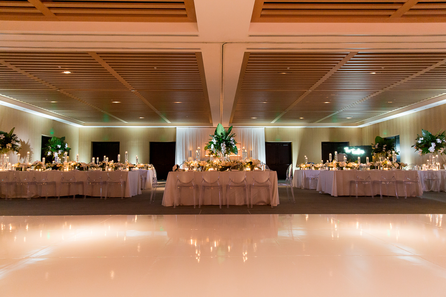 Candles and orchids on a table during a wedding by Avante Gardens at the Miami Beach Edition.