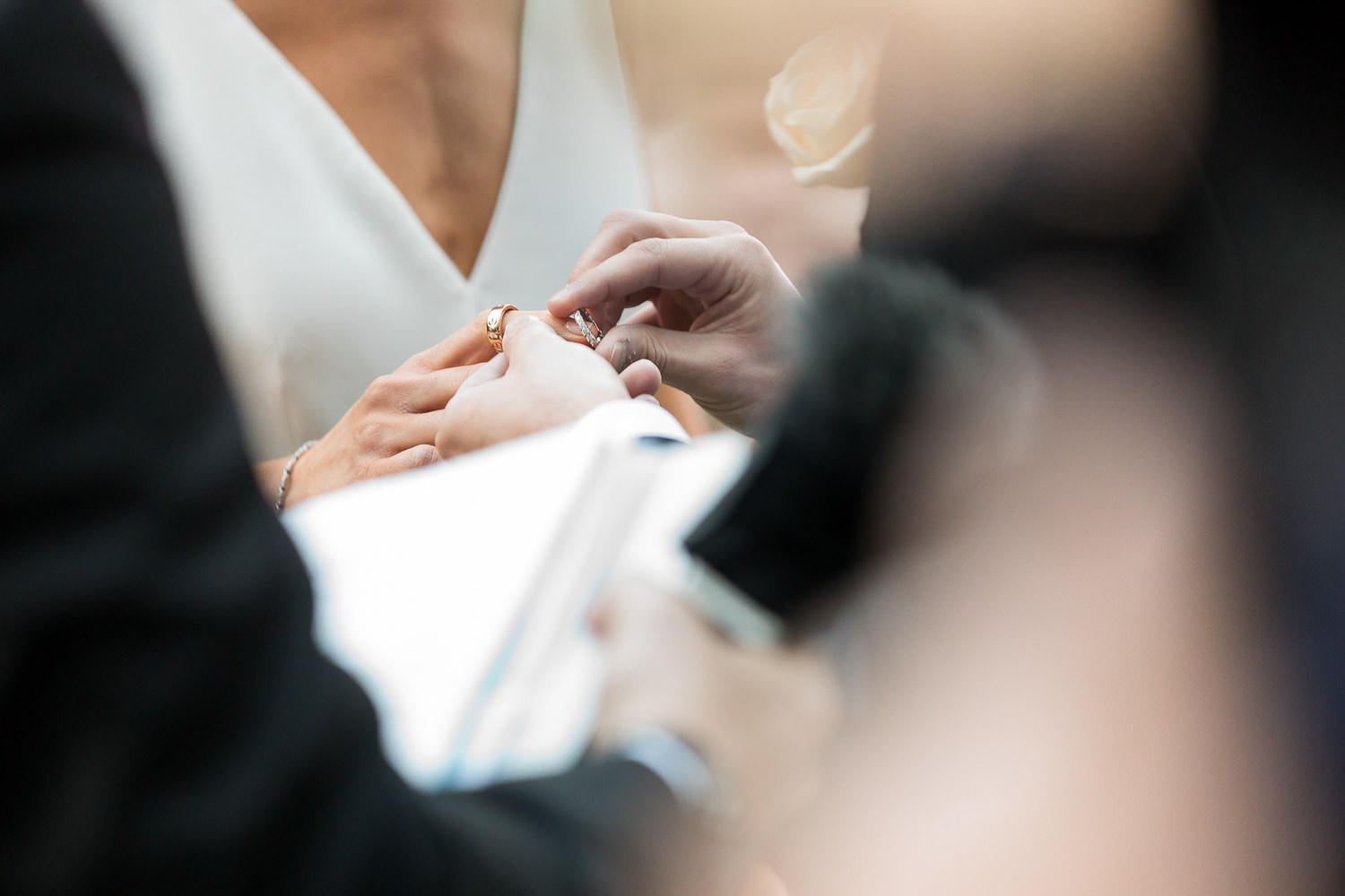 The exchange of wedding rings during a ceremony at the Miami Beach Edition.