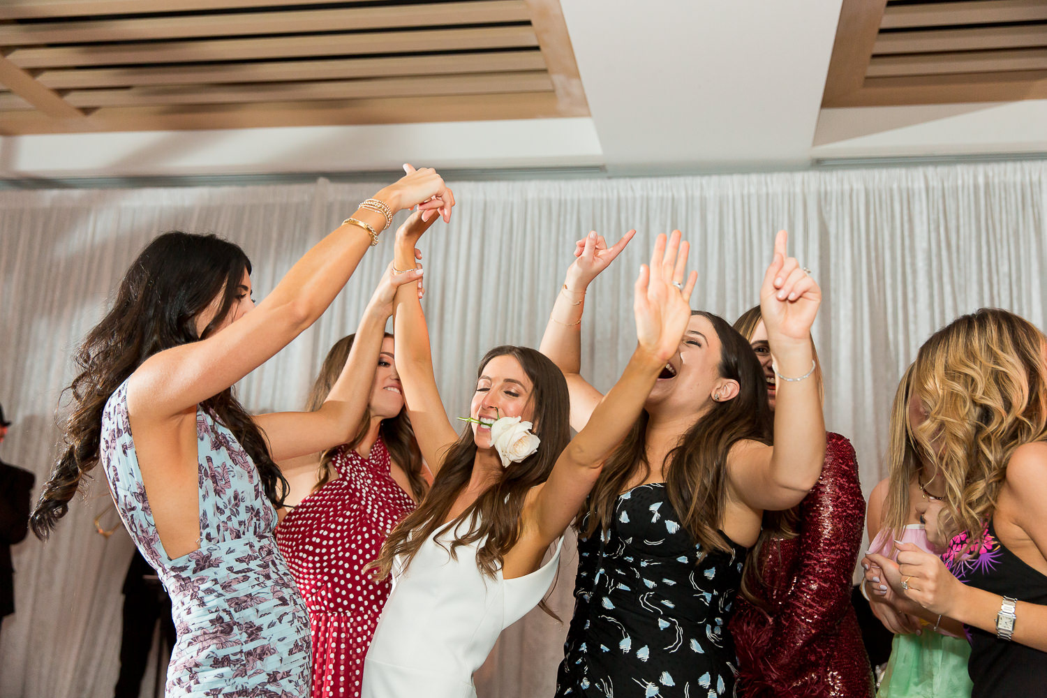 Bride dancing on stage with her friends at the Edition on Miami Beach.