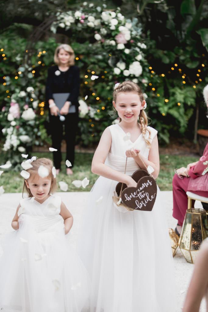 A bride and groom walk down the aisle after their wedding ceremony at home in Miami.