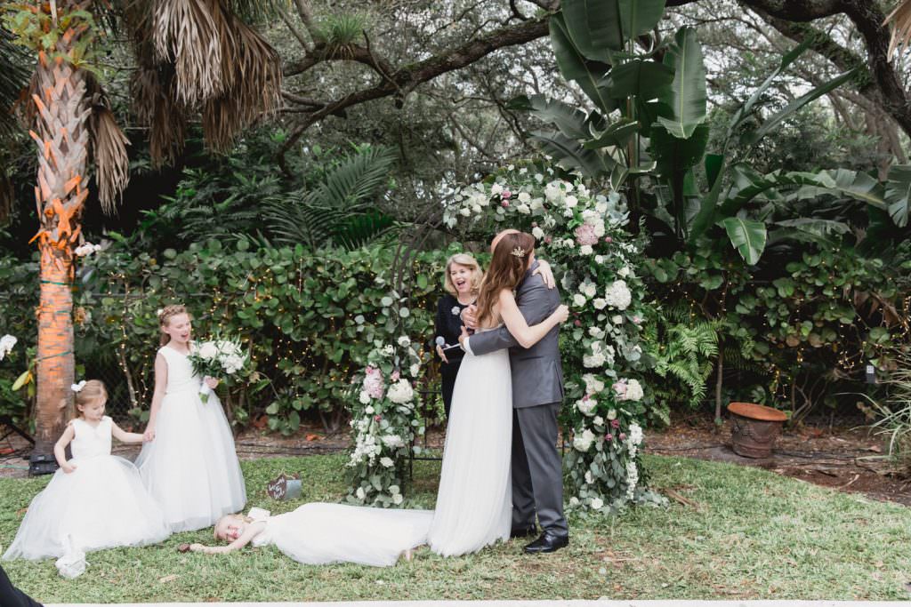 A bride and groom walk down the aisle after their wedding ceremony at home in Miami.