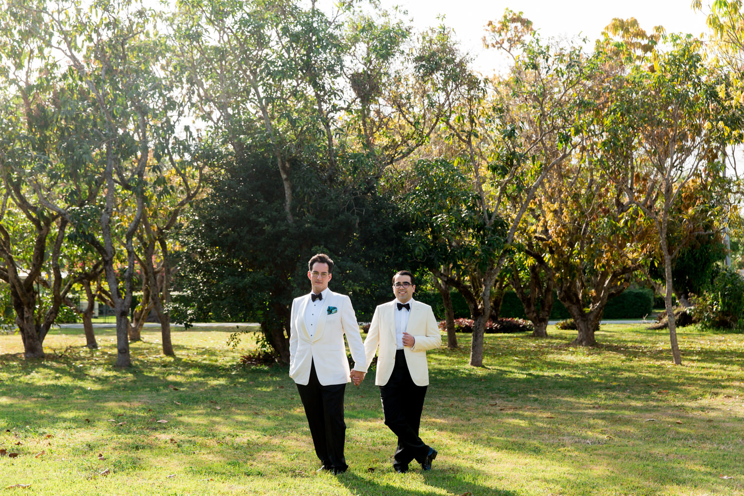 Two grooms take portraits during their at home wedding in Miami.