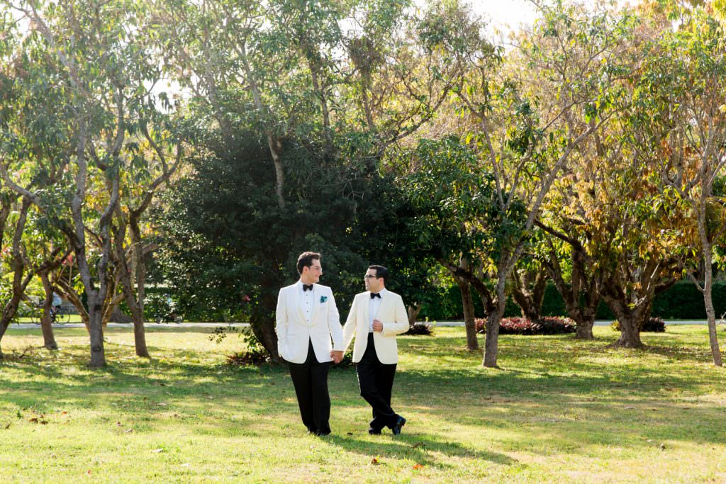 Two grooms take portraits during their at home wedding in Miami.