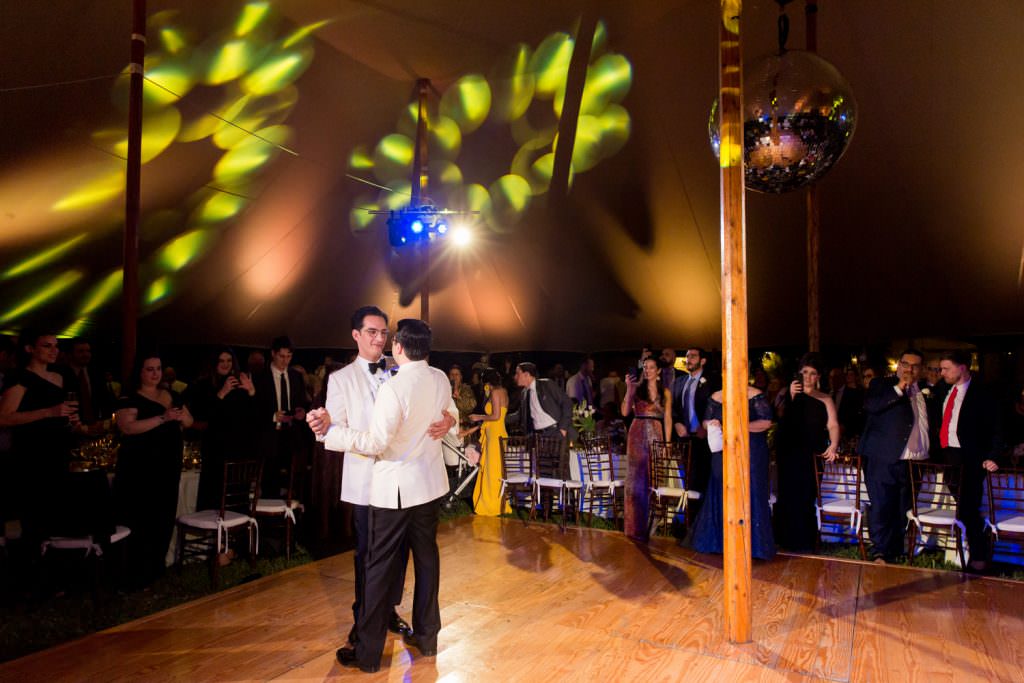 Two grooms share a first dance during their at home wedding in Pinecrest.