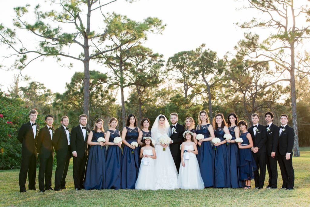 Bridal party takes portraits during their elegant tented backyard wedding in Palm Beach.