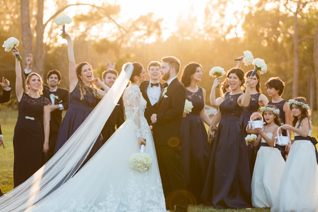 Bridal party takes portraits during their elegant tented backyard wedding in Palm Beach.