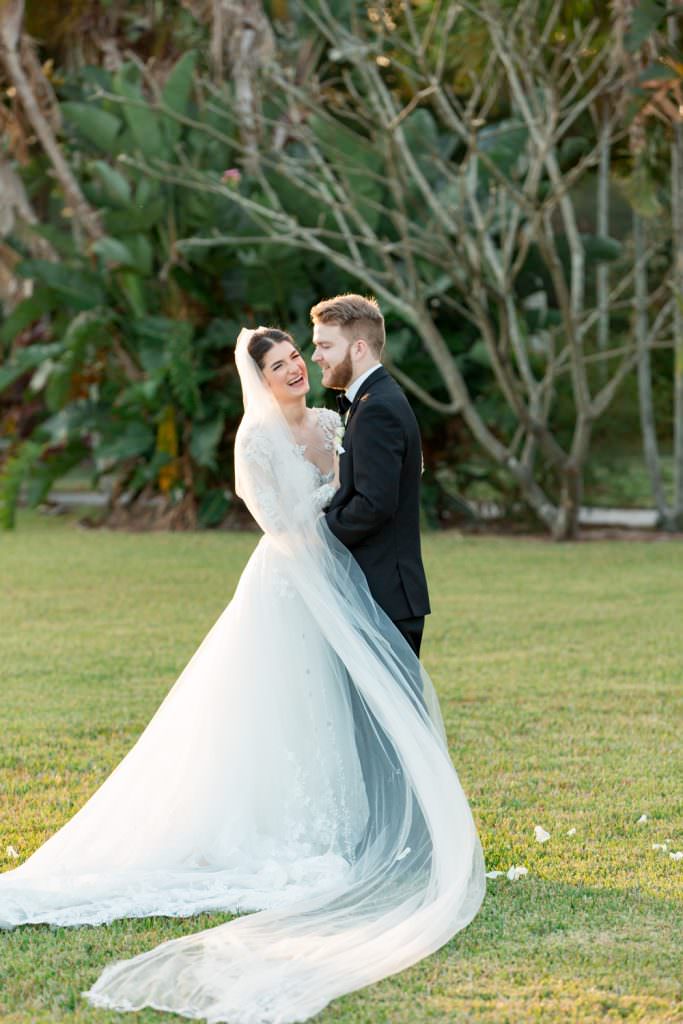 Bride and groom share a smile during their at home wedding reception in Palm Beach.
