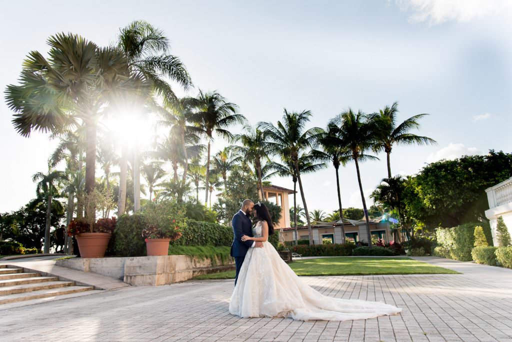 Bride and groom posing for a photo in courtyard at the Biltmore Hotel on their wedding day.