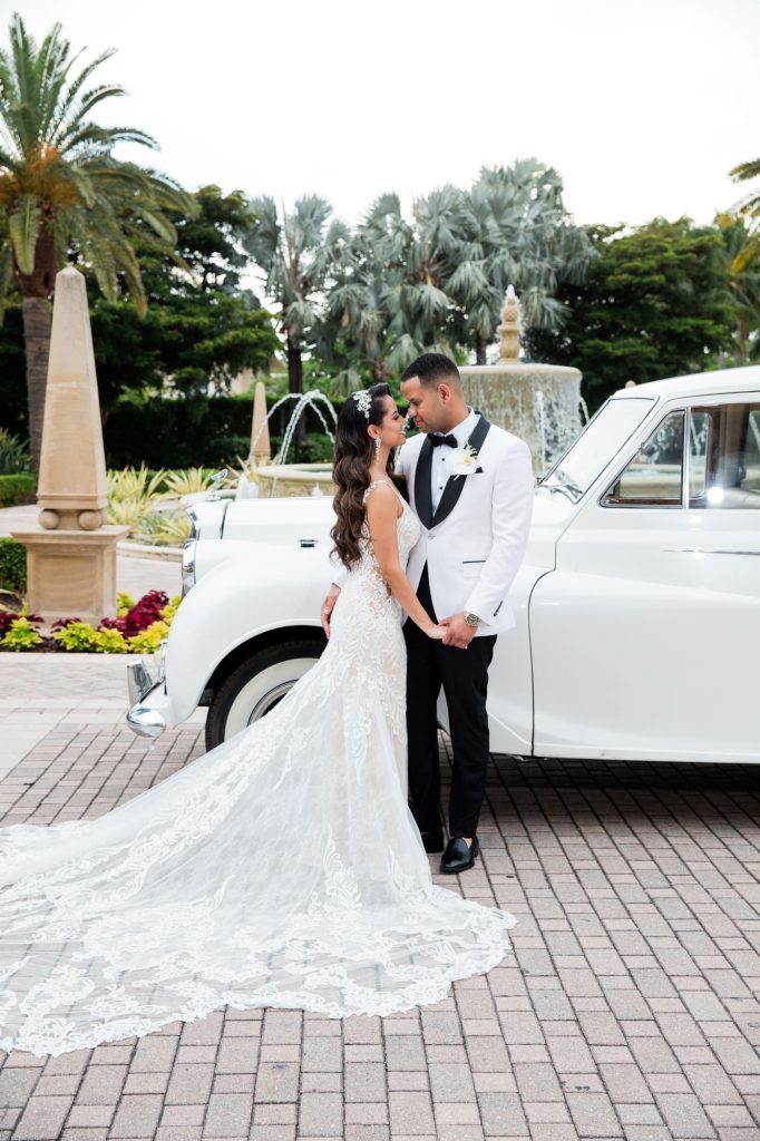 bride and groom have a wedding portrait next to their vintage wedding car at The Ritz-Carlton, Key Biscayne