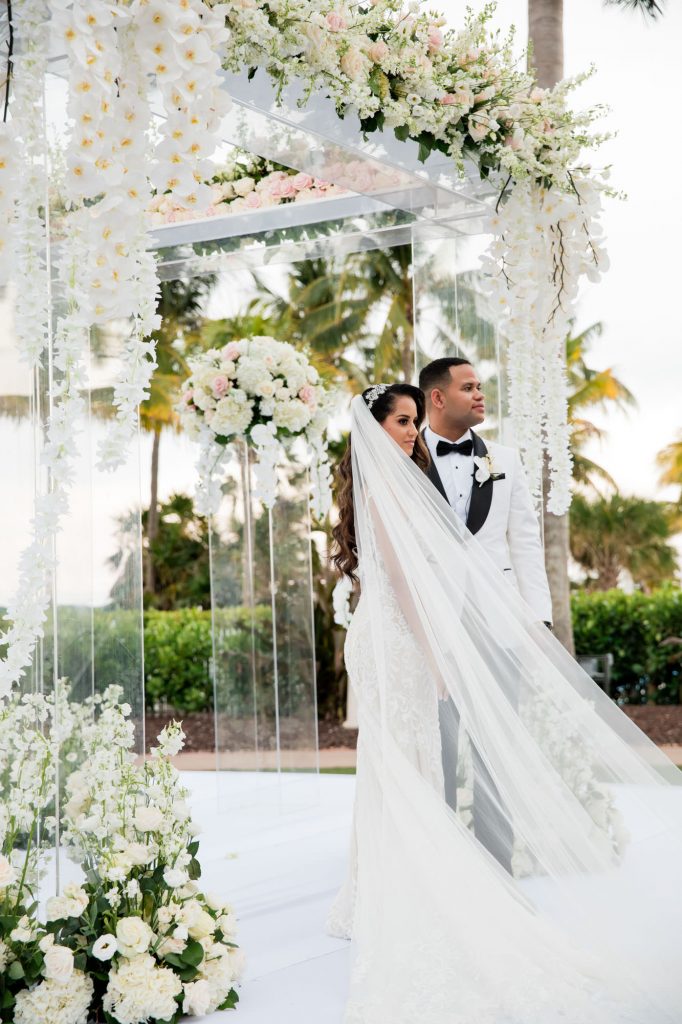 bride and groom face guests after exchanging views on the ocean lawn