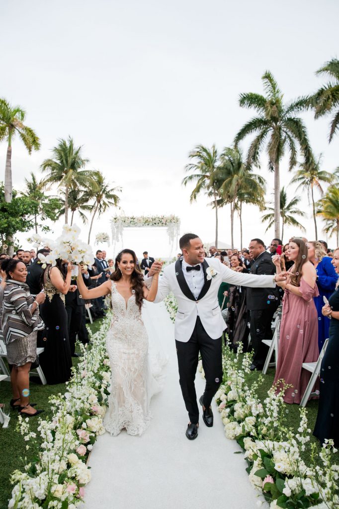bride and groom walk back up the aisle together as husband and wife