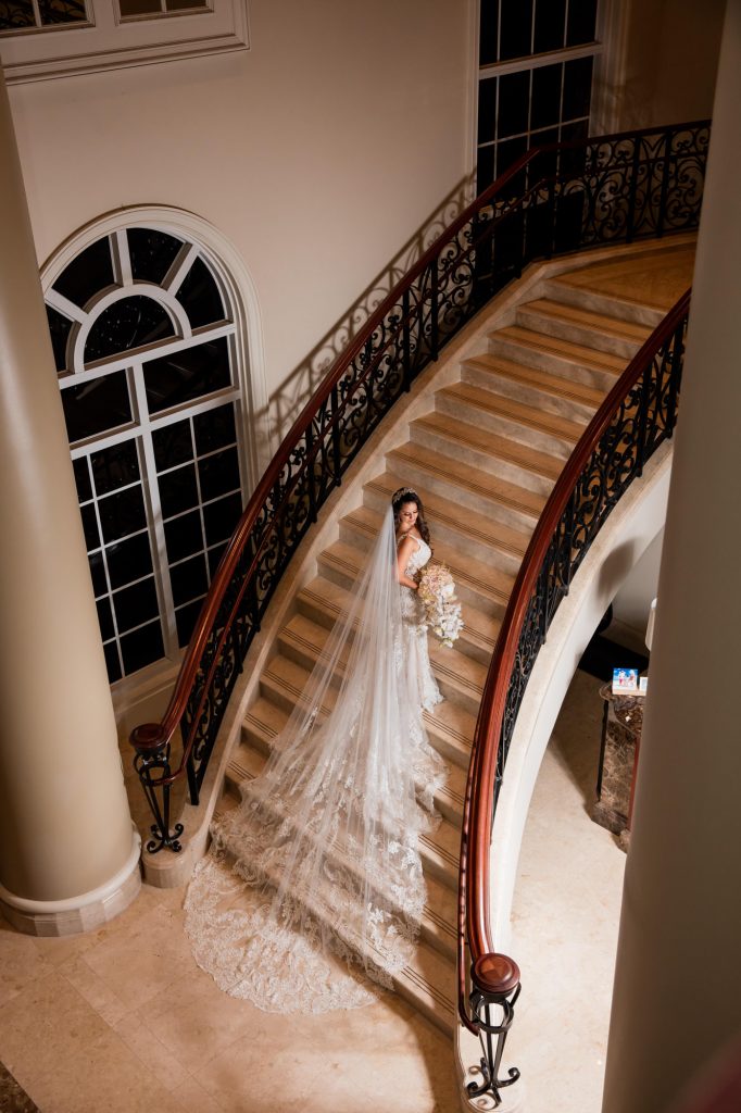 bride and groom pose for a portrait on the stairs on their wedding day at the RitZ-Carlton Key Biscayne