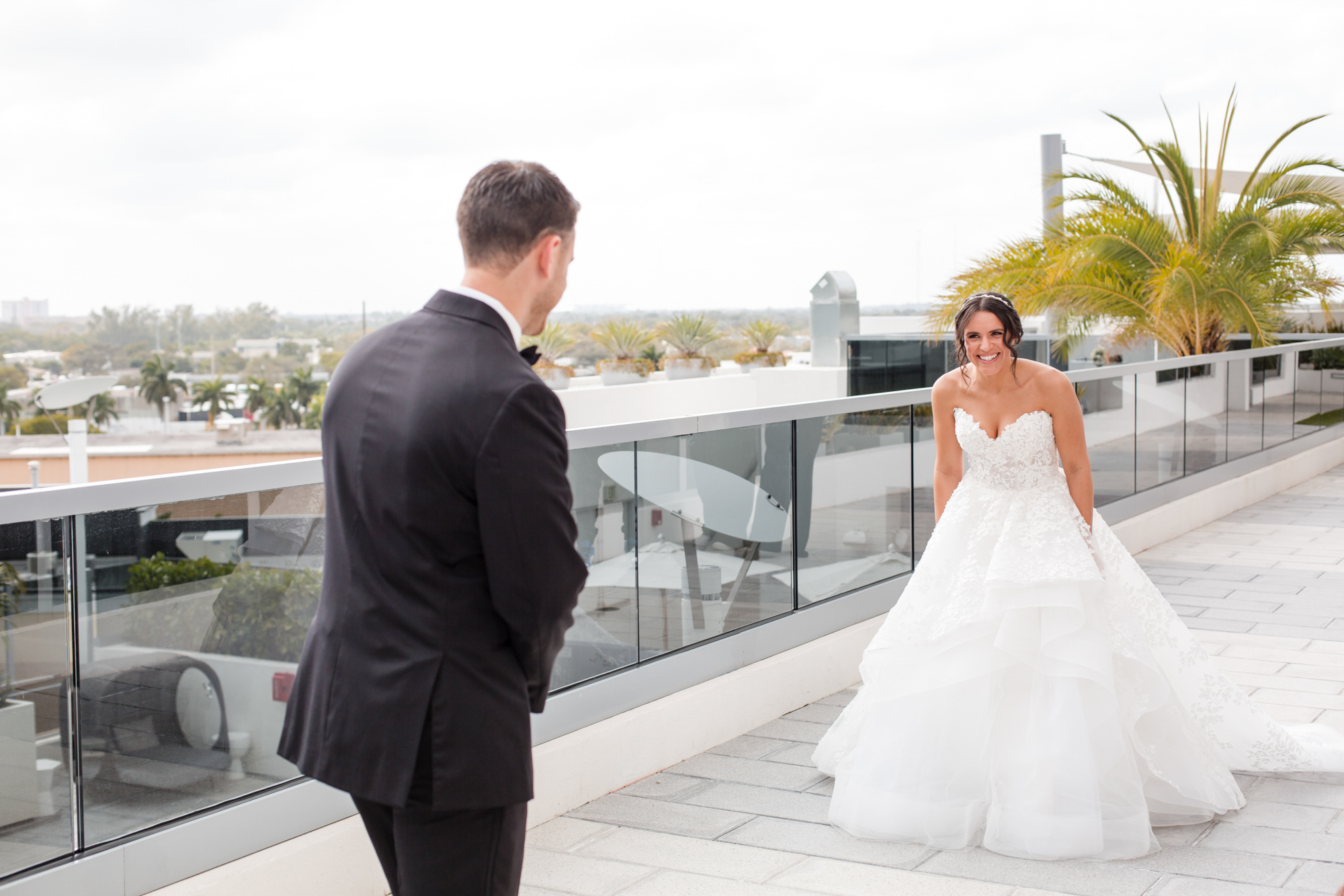groom sees his bride in her dress for the first time during the first look