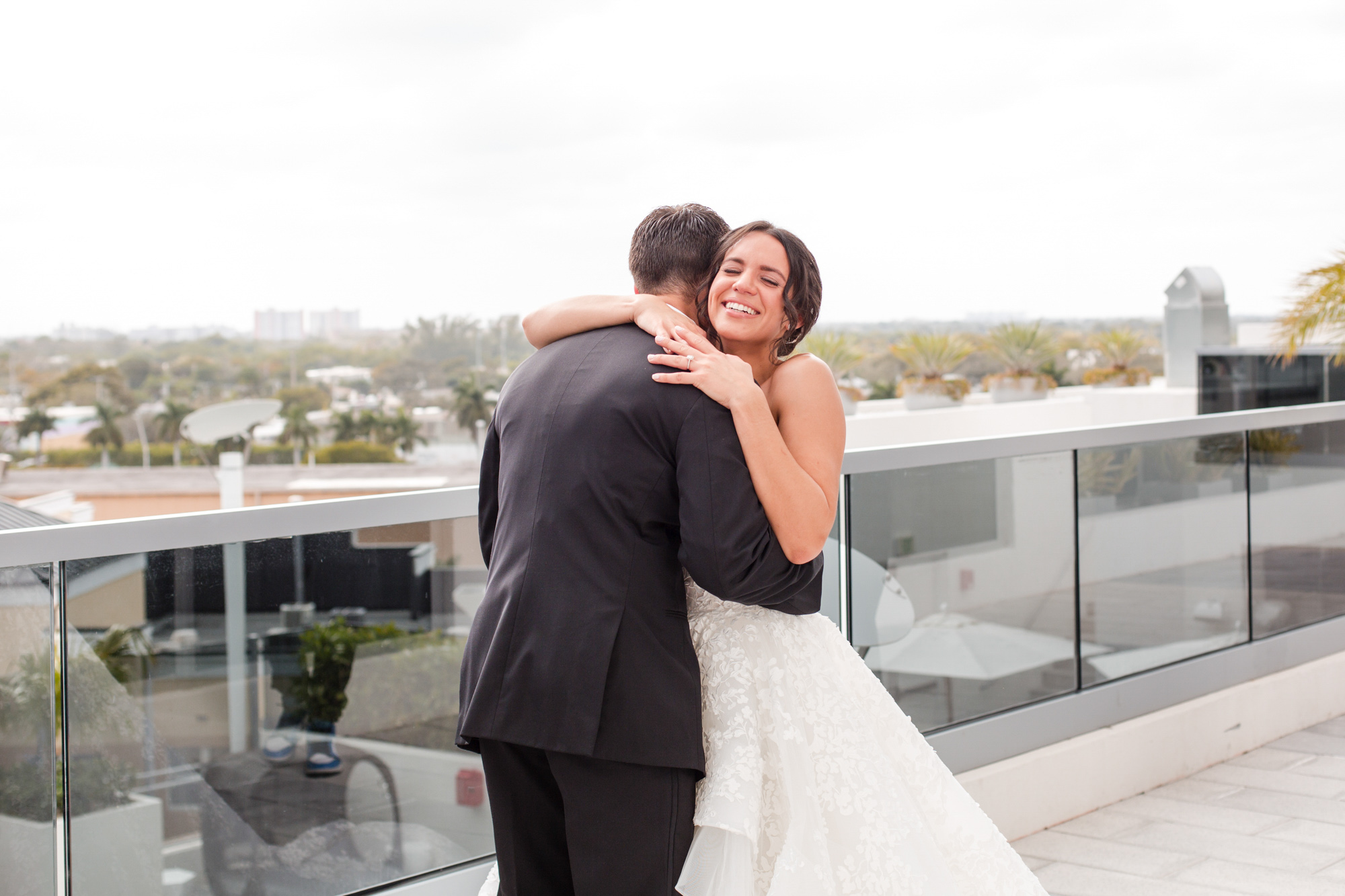 bride embraces groom in a hug during the first look