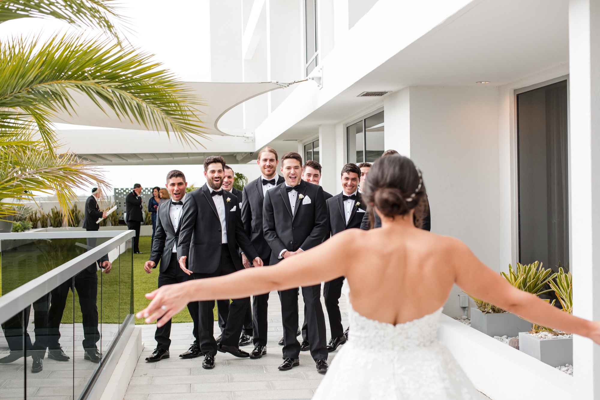the groomsmen see the bride in her wedding dress