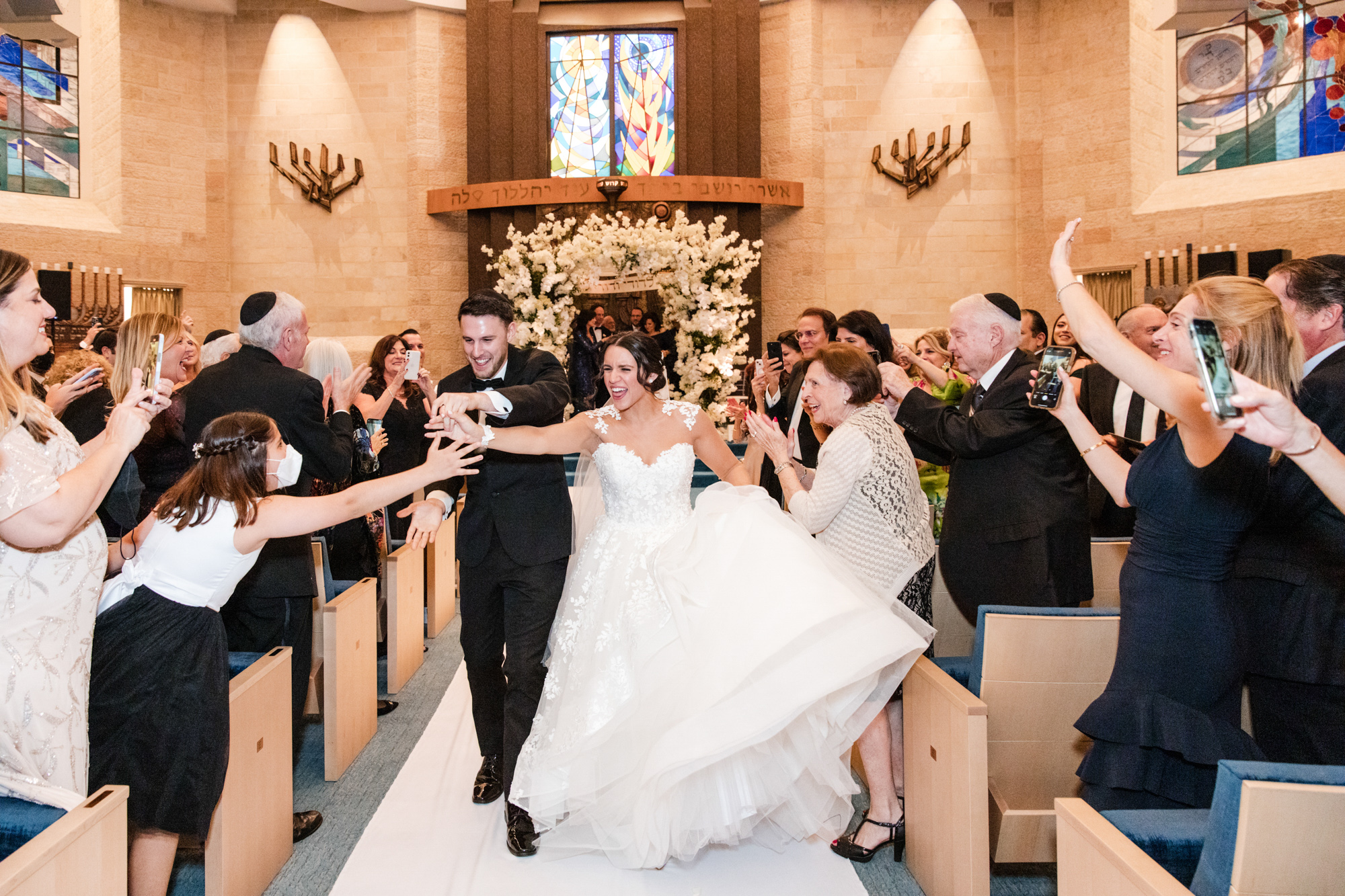 bride and groom walk up the aisle together at their Beth Torah Benny Rok Temple Wedding 