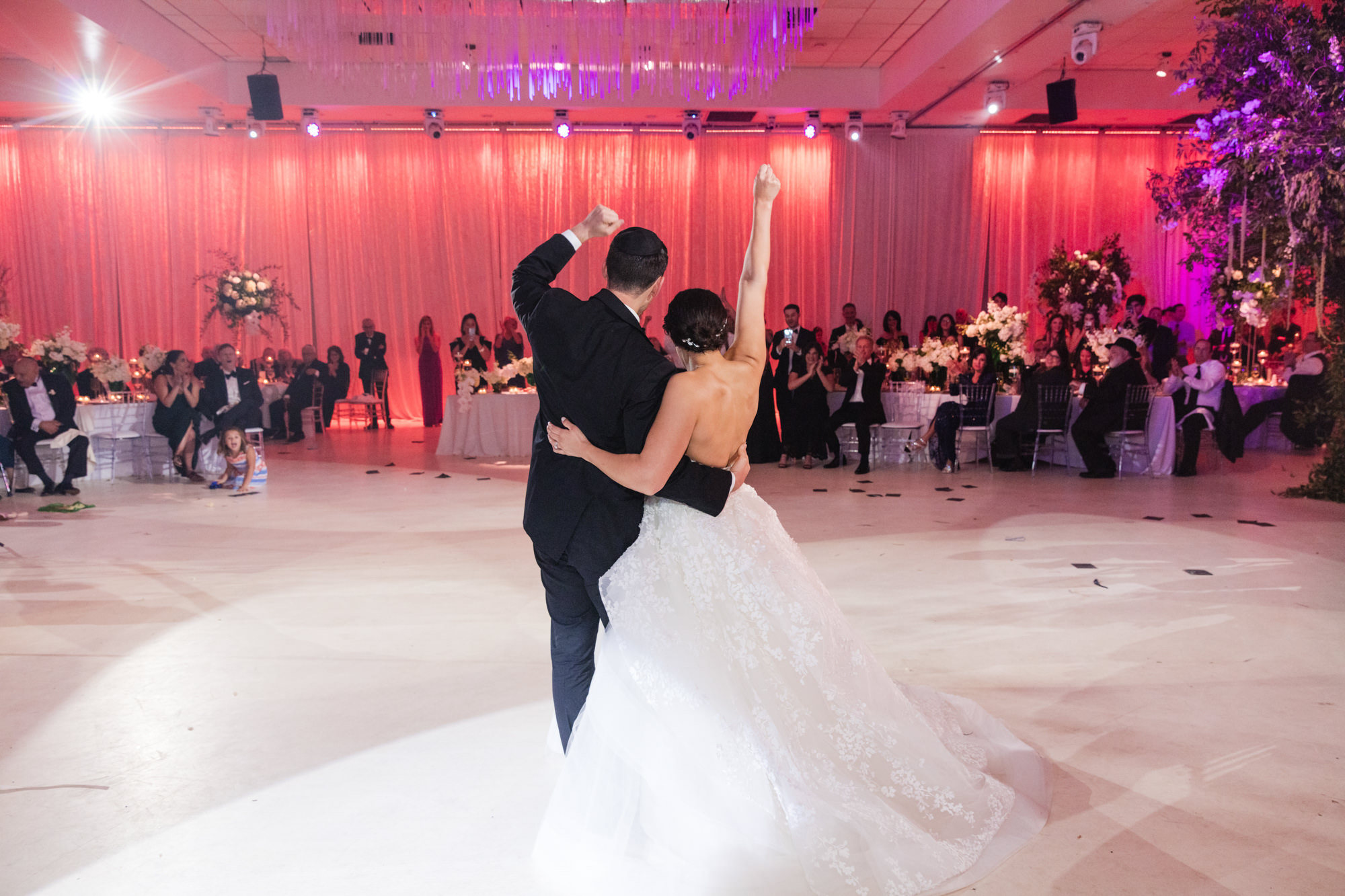 bride and groom wave to guests after their first dance