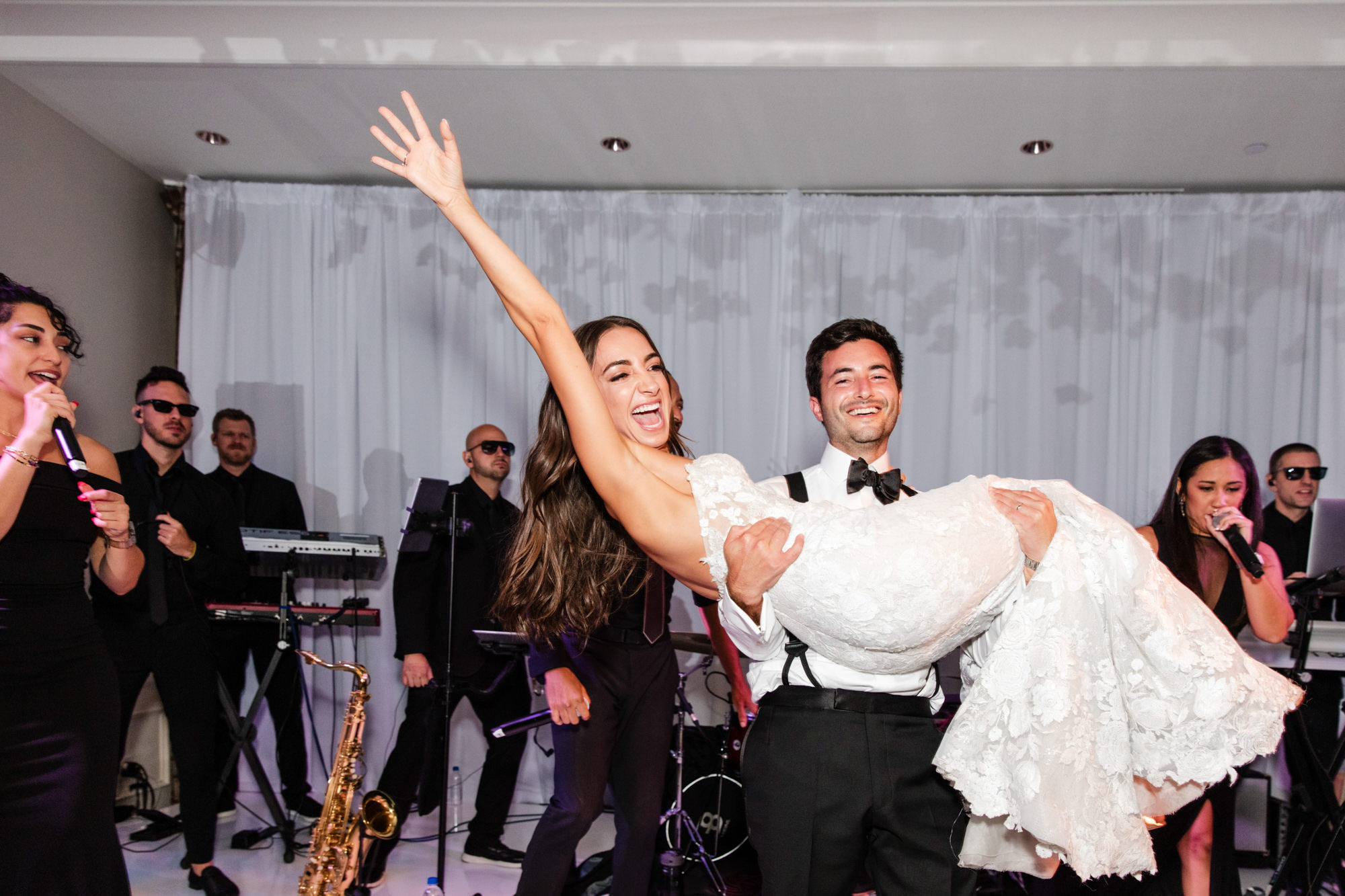 groom picks up bride at the end of their first dance as husband and wife