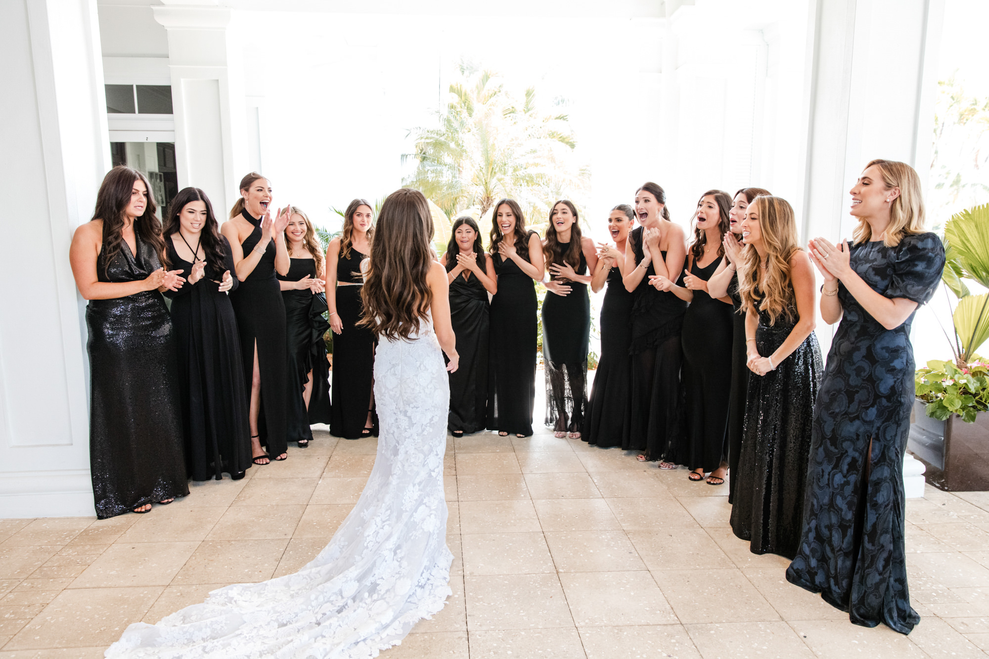 bride walks out to meet bridesmaids in her wedding dress