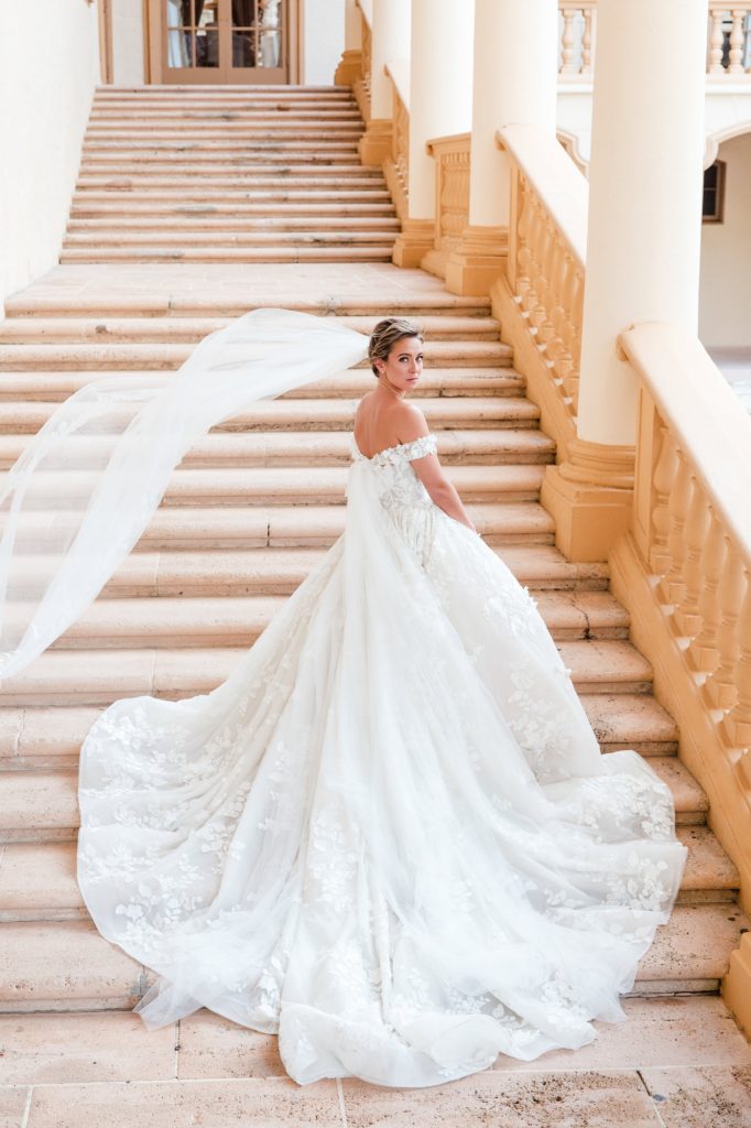 bride on stairs of the Biltmore Hotel, Miami as her veil blows in the breeze