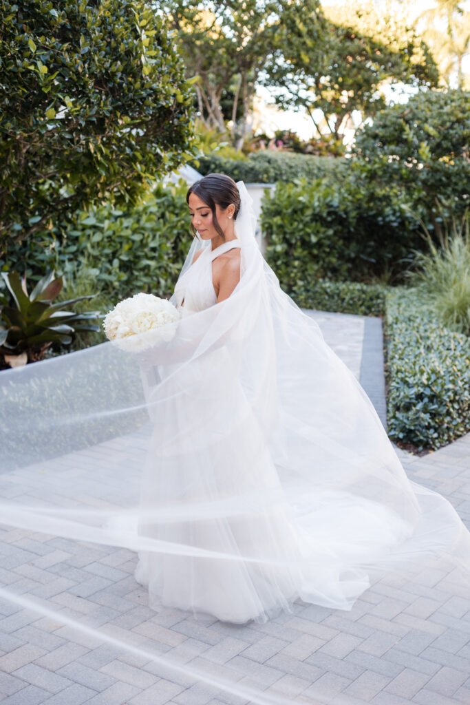Bride standing on Polo Club Boca Raton grounds with soft natural light