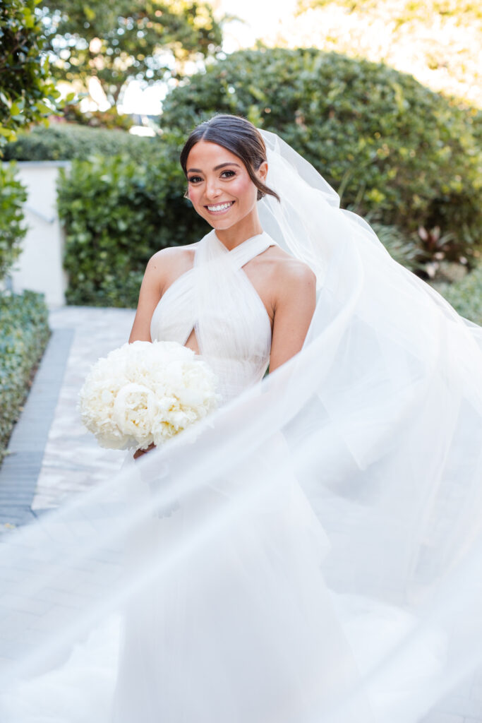 Bride standing on Polo Club Boca Raton grounds with soft natural light