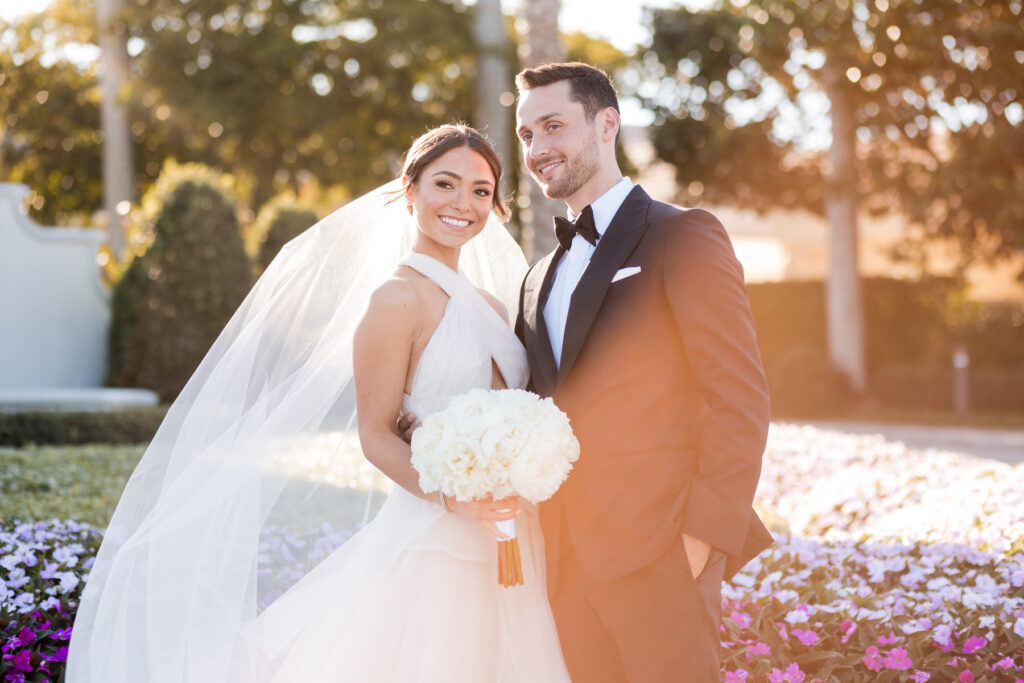Groom smiling at bride during their wedding portraits in Boca Raton
