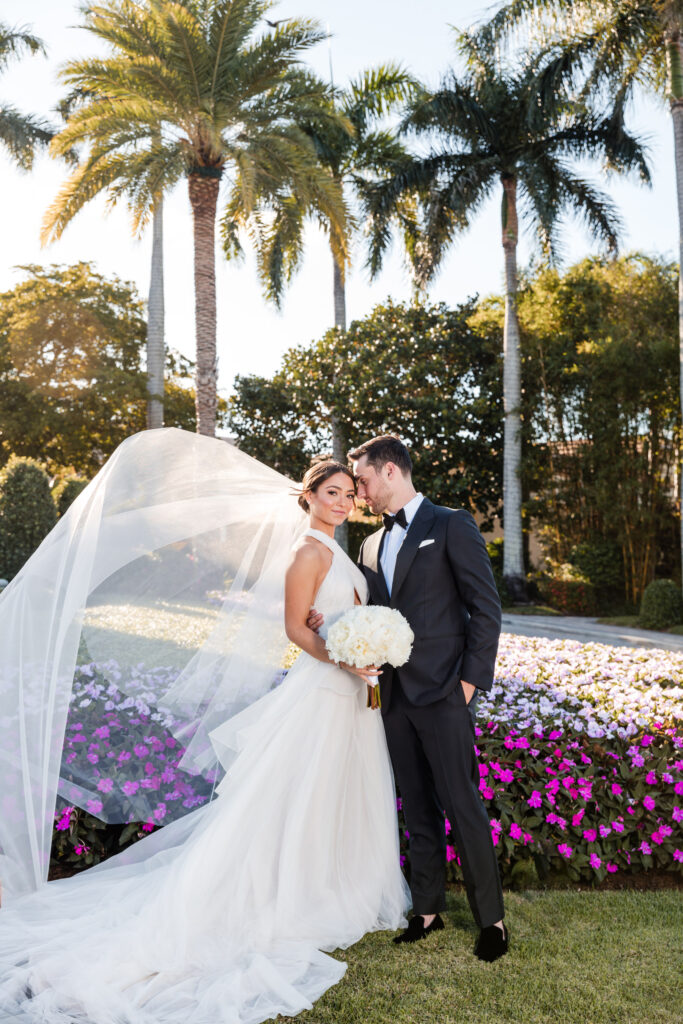 Bride and groom portrait with tropical trees and golf course backdrop