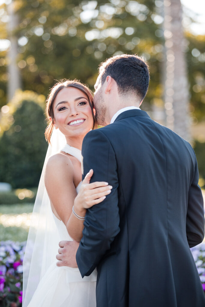Bride smiling at groom during portrait session at the Polo Club