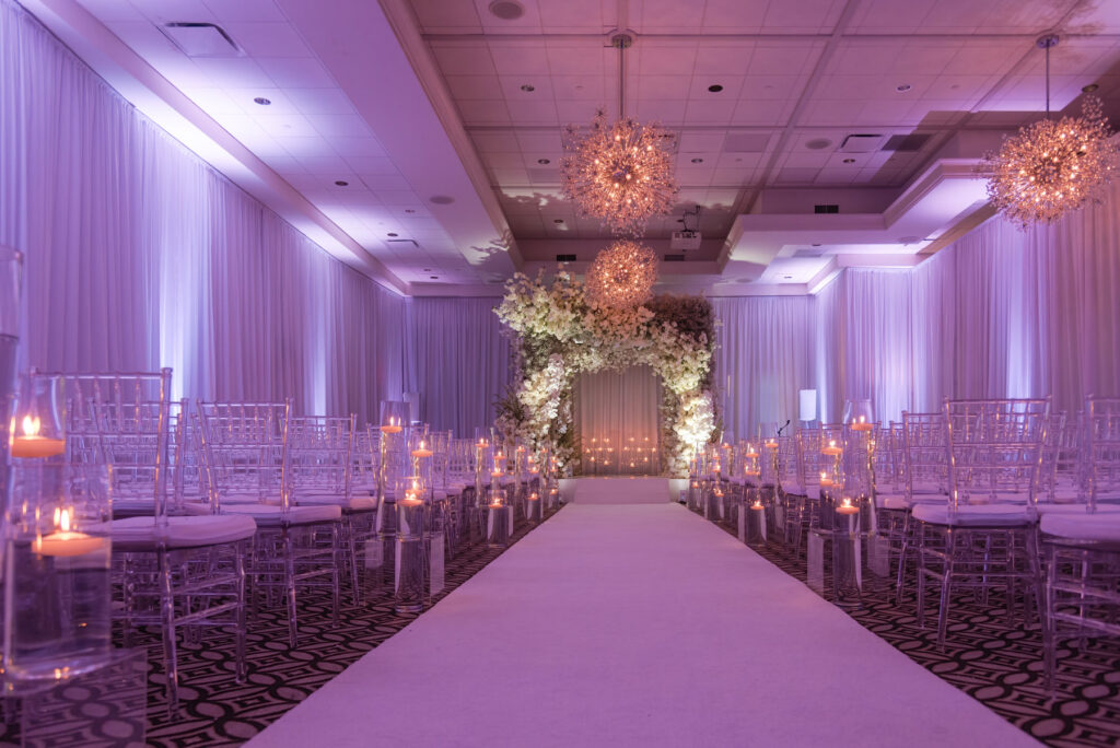 Close-up of chuppah details with flowing fabric and floral accents