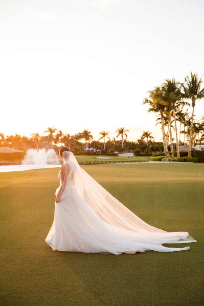 Bride walking together on the Polo Club golf course at sunset in Boca Raton