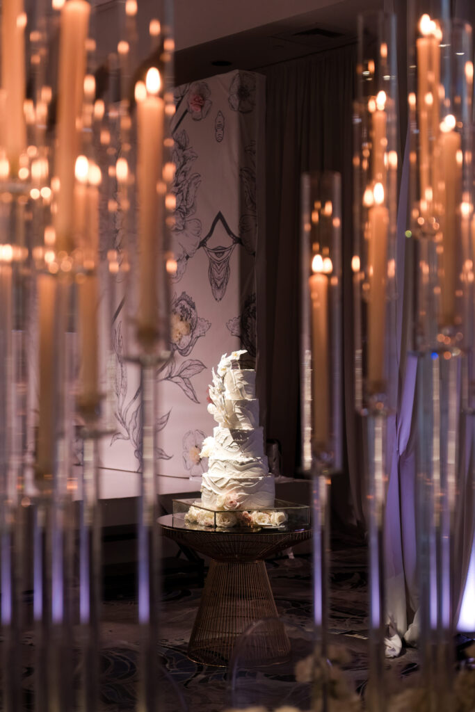 Wedding cake display with classic white design and floral accents