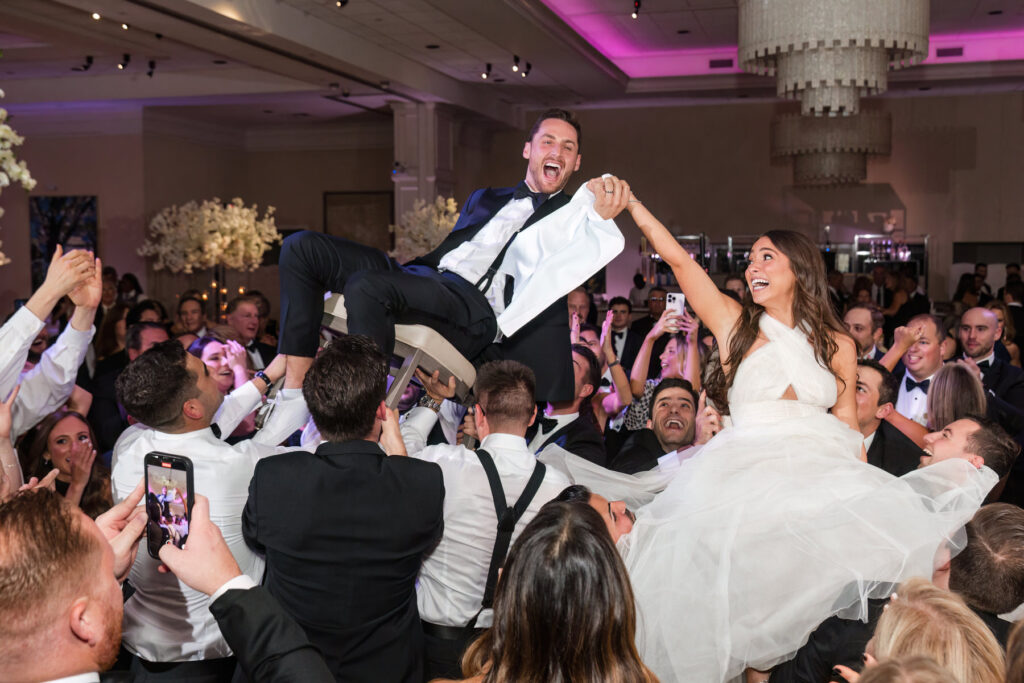 Guests dancing and celebrating during the energetic hora at the Polo Club wedding