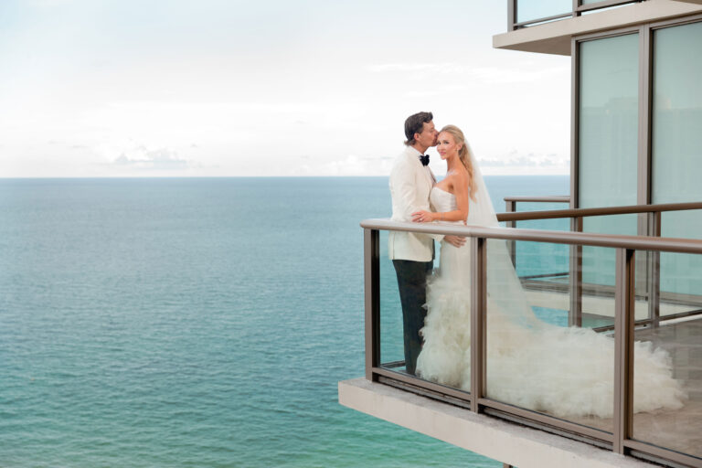 Bride and groom on balcony at the St. Regis hotel in Bal Harbor.