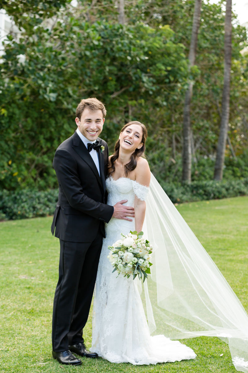 Bride and groom laughing during their wedding portrait session at the RItz Carlton Key Biscayne.