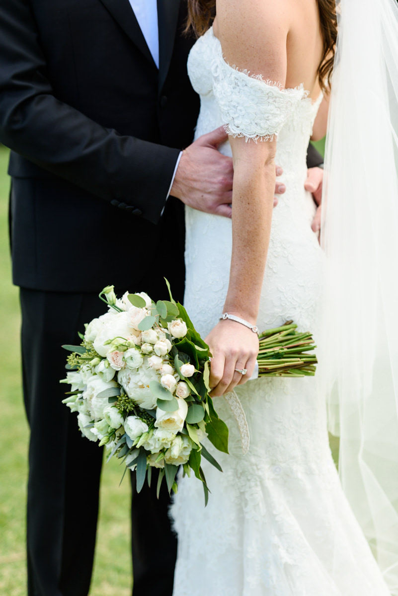 A white bridal bouquet against a lace dress at the Ritz Carlton on Key Biscayne.