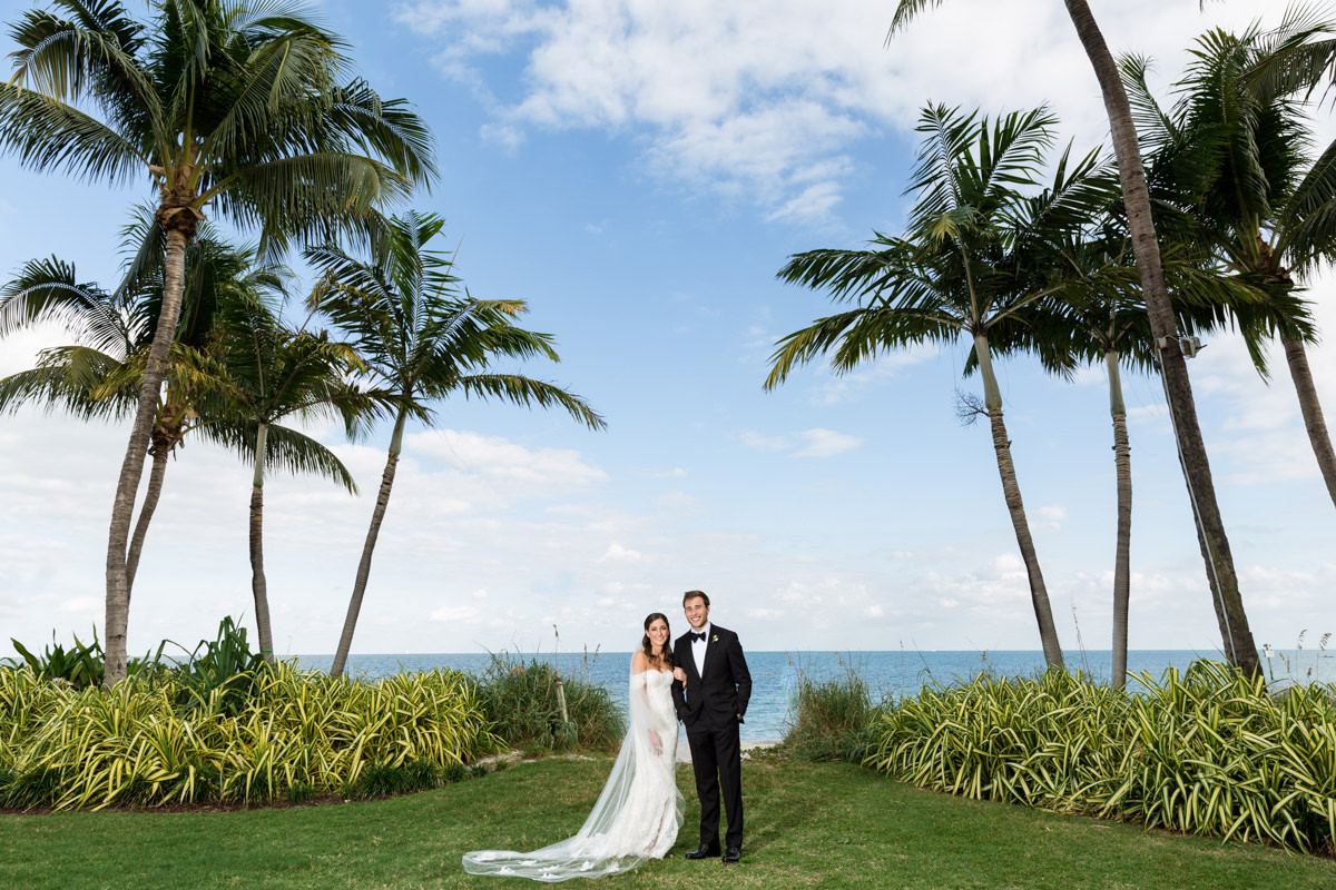 A couple posing by the ocean at the Ritz Carlton in Key Biscayne.