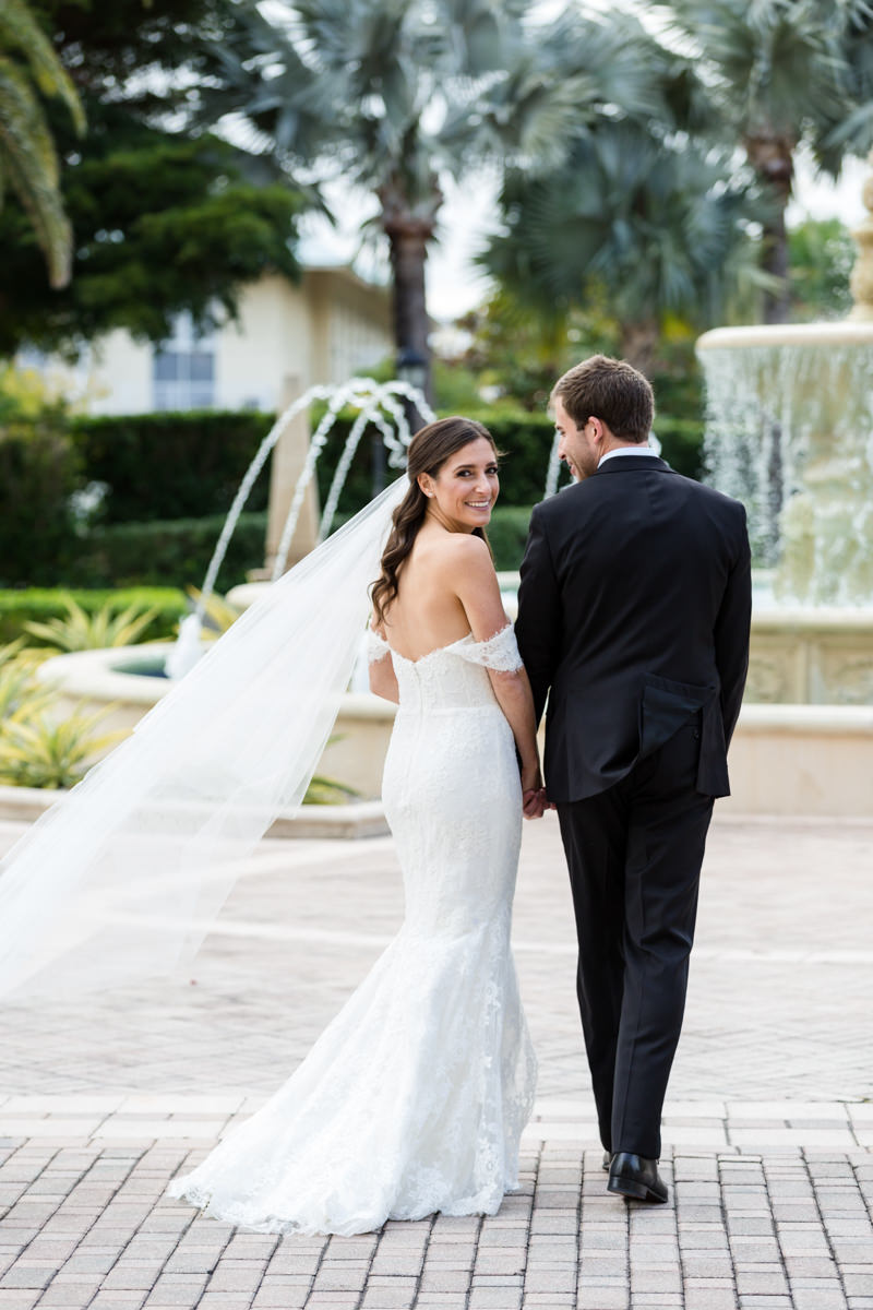 Bride and groom walking towards the fountain at the Ritz Carlton in Key Biscayne.