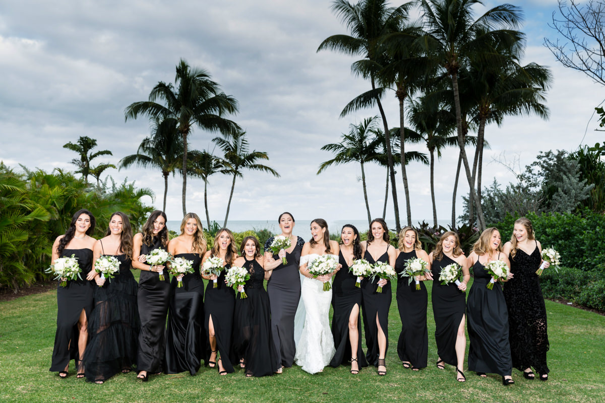 Bridesmaids in black dresses walking together at the Ritz Carlton in Key Biscayne.