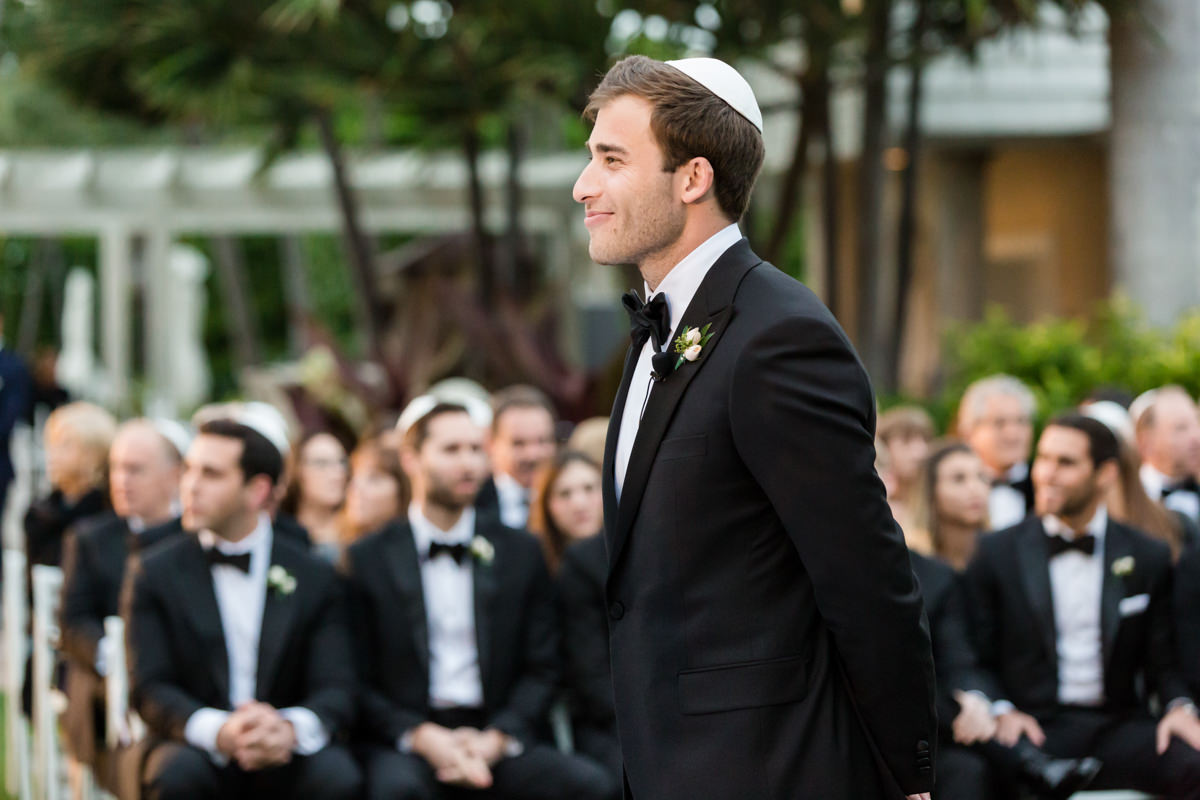 Groom waiting for his bride to walk down the aisle Flower girl passing out flowers at the Ritz Carlton in Key Biscayne.