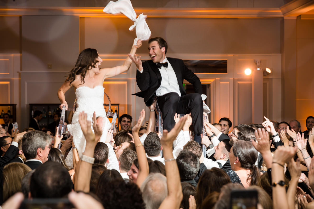Bride and groom in chairs during the hora at the Ritz Carlton on Key Biscayne.