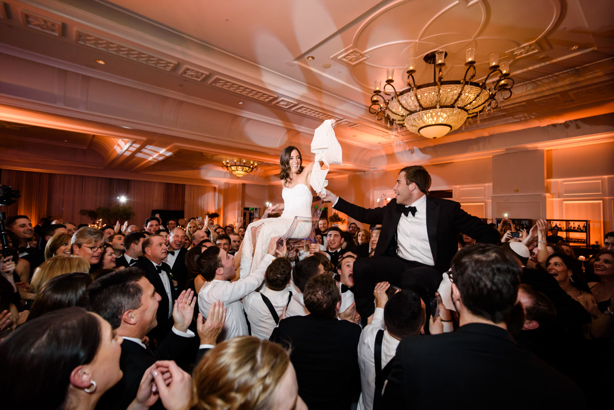 Bride and groom in chairs during the hora at the Ritz Carlton on Key Biscayne.