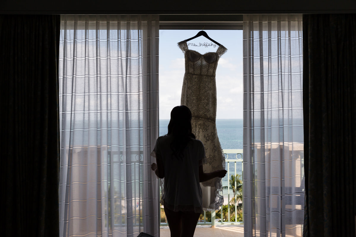 Bride and her wedding gown in a window at the Ritz Carlton in Key Biscayne.