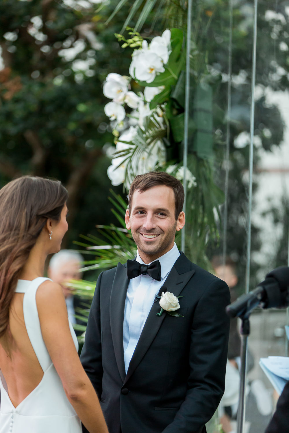 Bride and groom smiling during their ceremony at the Edition on Miami Beach.