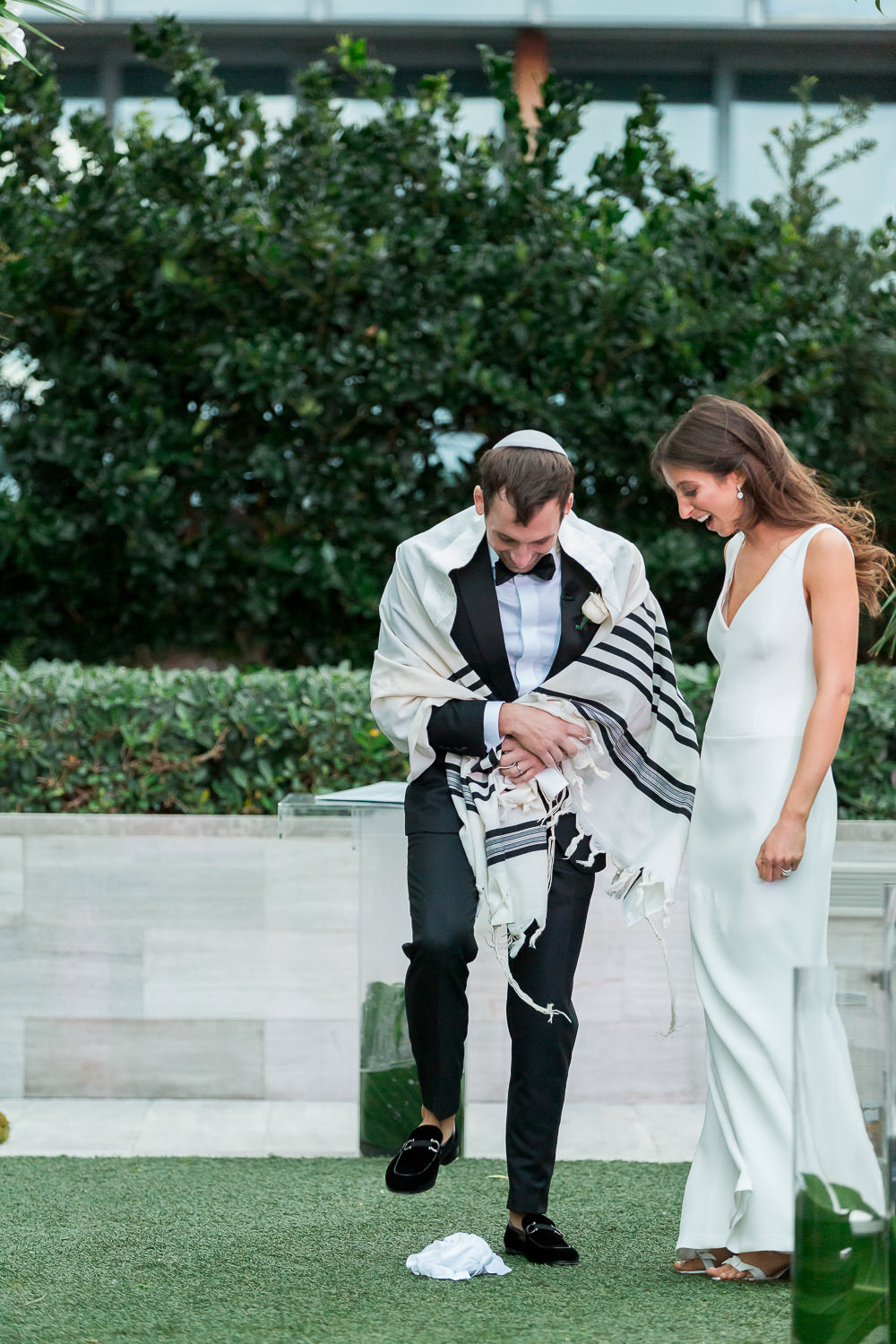 Bride and groom kiss at the end of aisle during their ceremony at the Edition on Miami Beach.