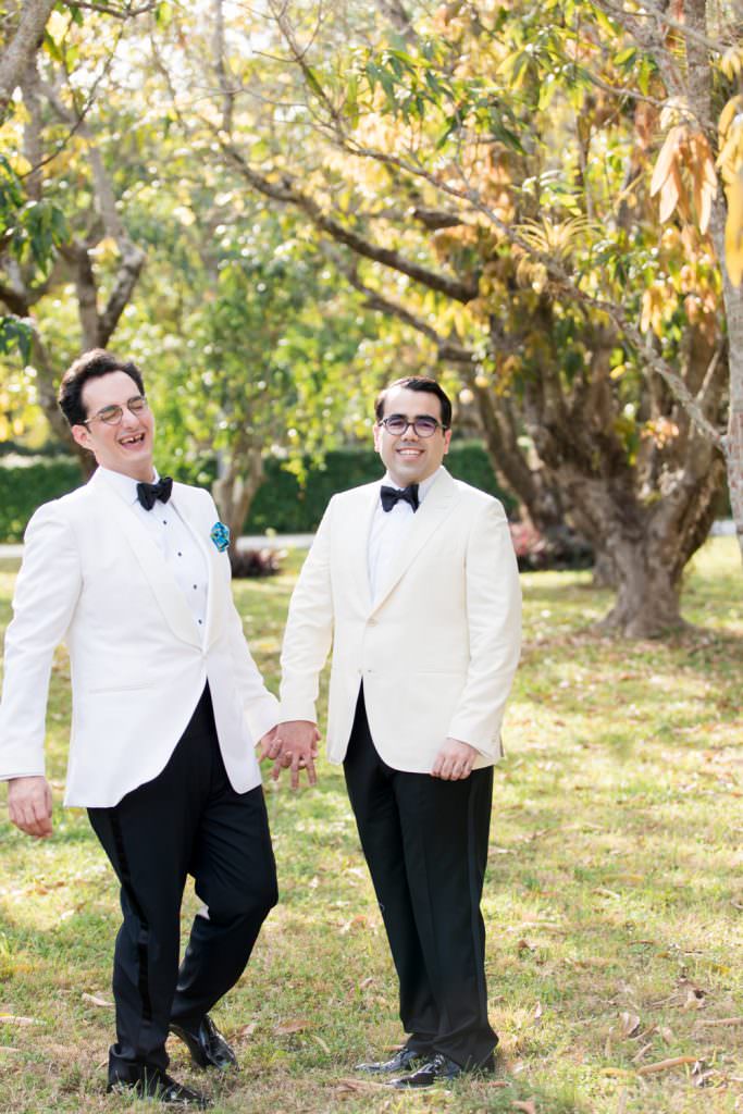 Two grooms take portraits during their at home wedding in Miami.