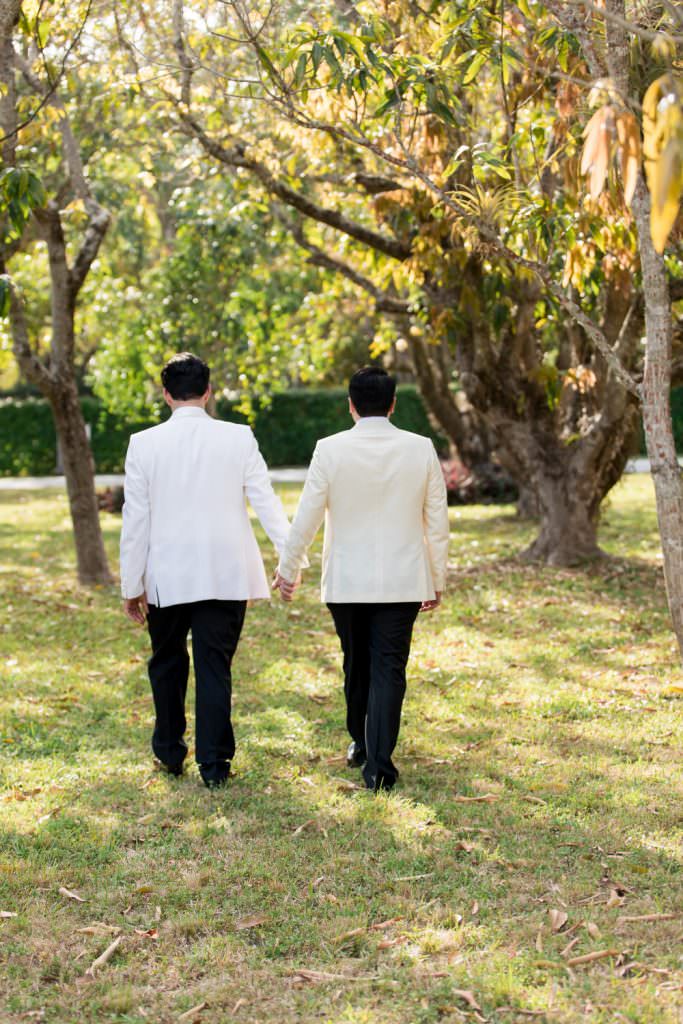 Two grooms take portraits during their at home wedding in Miami.