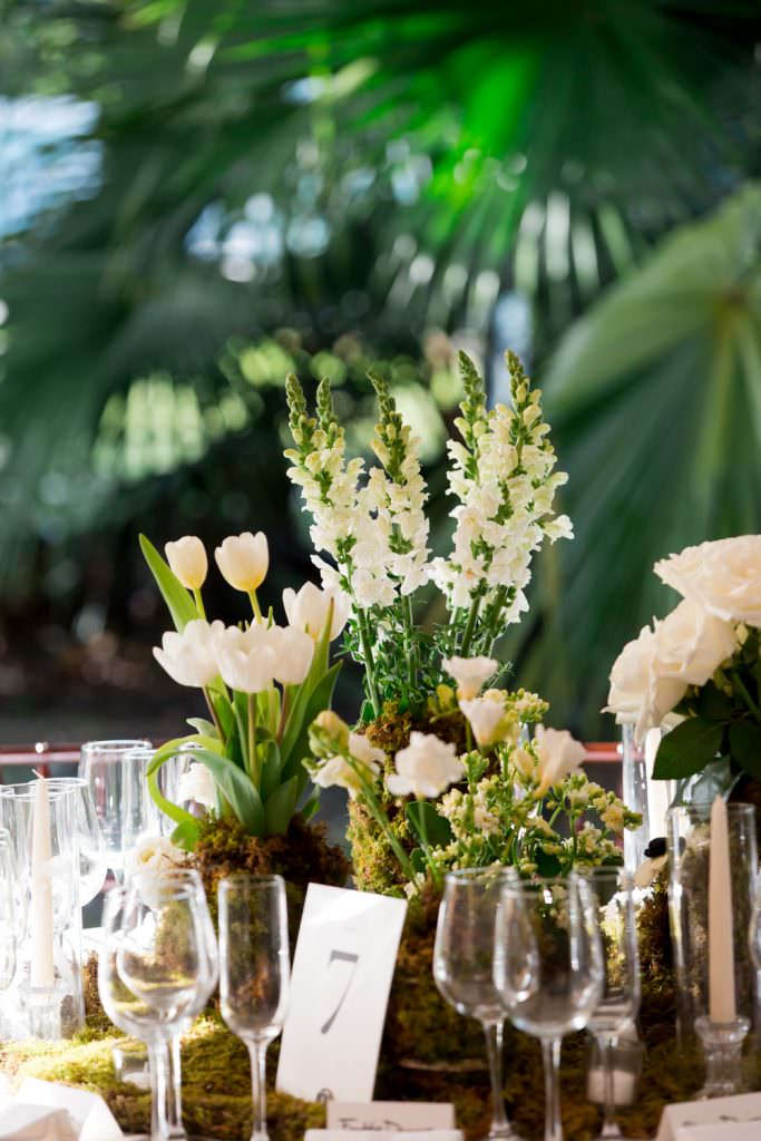 White tulips and candles illuminate a wedding tent in Miami.